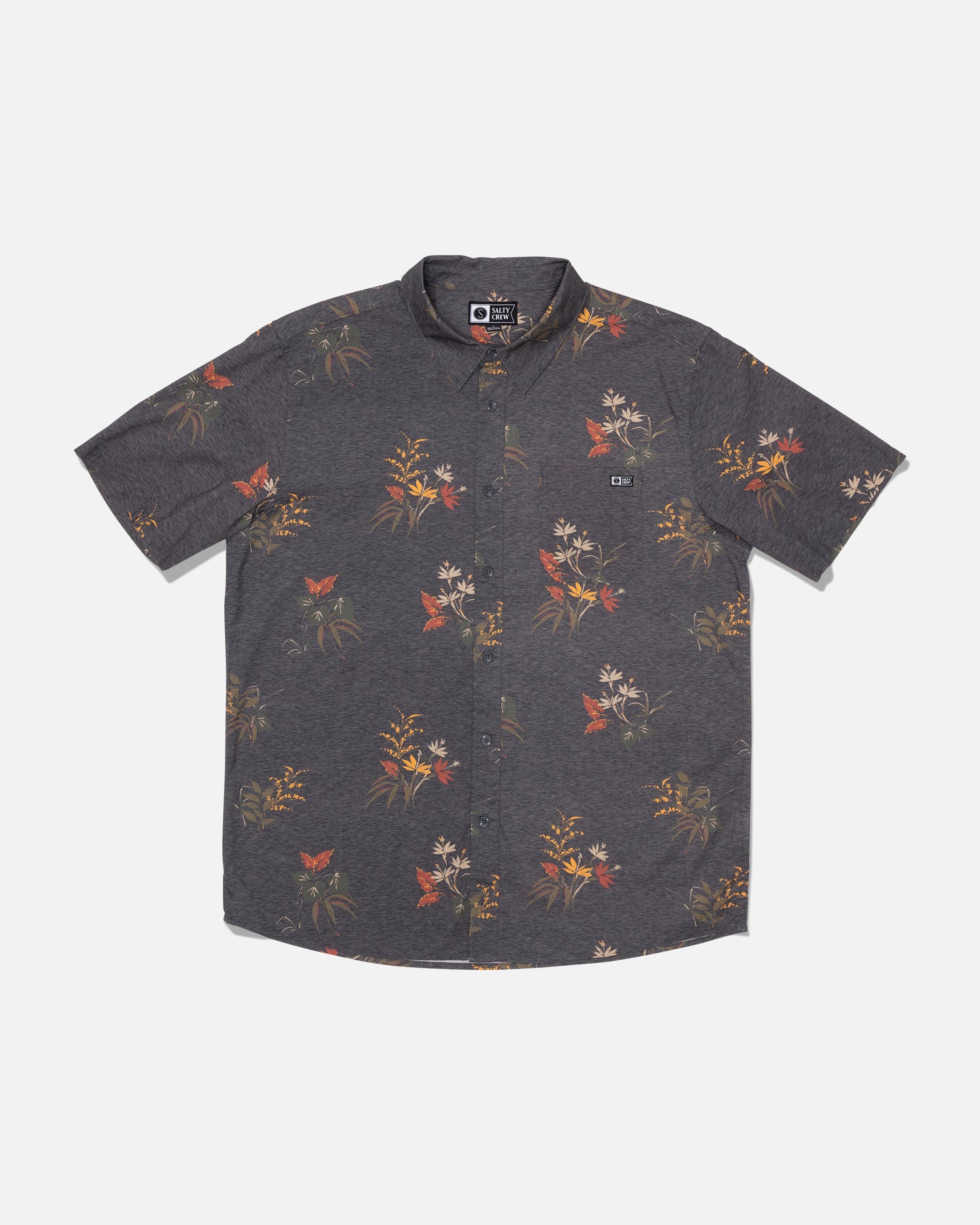 Salty Crew’s Crew Button Up in Off Black is a short-sleeved, button-up shirt made from a comfortable cotton blend. It features a dark gray background with an allover floral and butterfly print in muted red, yellow, and white tones. The shirt includes a collared neckline and a small chest pocket adorned with a logo tag, and is finished with a soft hand garment wash for enhanced comfort.