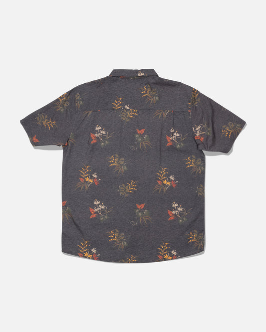 Salty Crew’s Crew Button Up in Off Black is a short-sleeve cotton blend shirt featuring a subtle allover floral and butterfly print in muted red, yellow, and green tones. Shown from the back against a plain white background, this shirt is finished with a soft hand garment wash for added comfort.