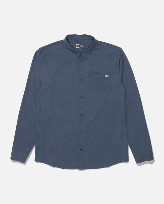 The Salty Crew Drifter Long Sleeve UV Button Up in Navy/Grey is laid flat on a white background. This shirt features a single chest pocket and is designed for comfort and performance, offering moisture-wicking and quick-dry properties to keep you cool and dry throughout the day.