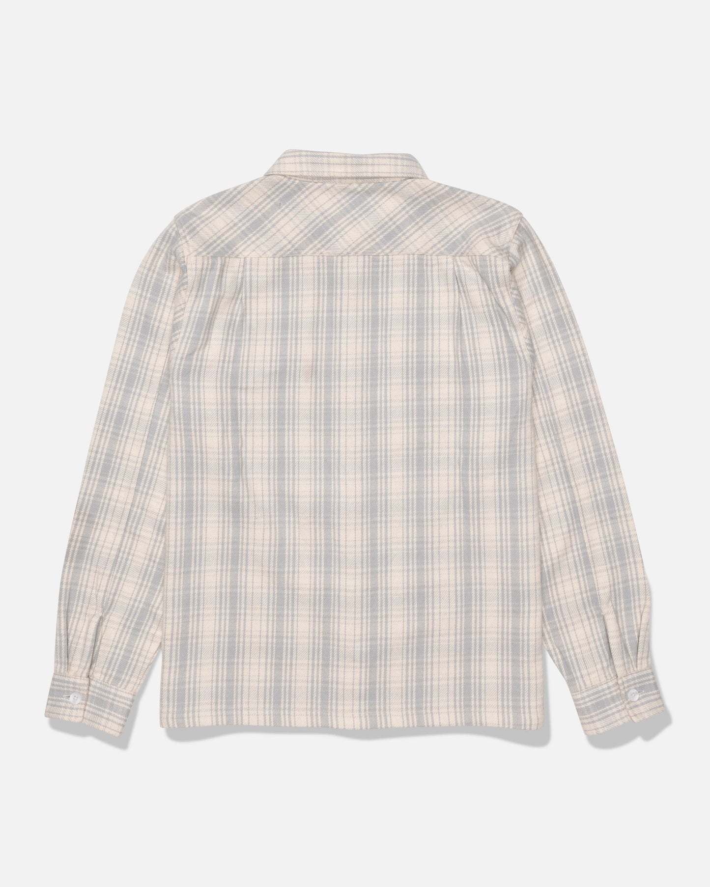The Salty Crew Windward Flannel in Off White, crafted from heavyweight cotton twill and garment-washed for extra softness, is displayed from the back on a plain white background; this long-sleeve shirt features button cuffs and a plaid pattern in light blue and beige tones.