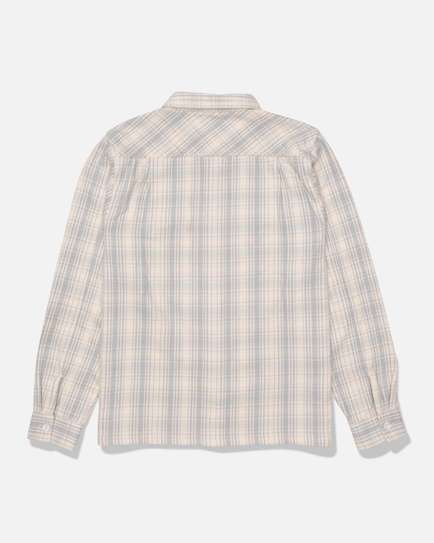 The Salty Crew Windward Flannel in Off White, crafted from heavyweight cotton twill and garment-washed for extra softness, is displayed from the back on a plain white background; this long-sleeve shirt features button cuffs and a plaid pattern in light blue and beige tones.