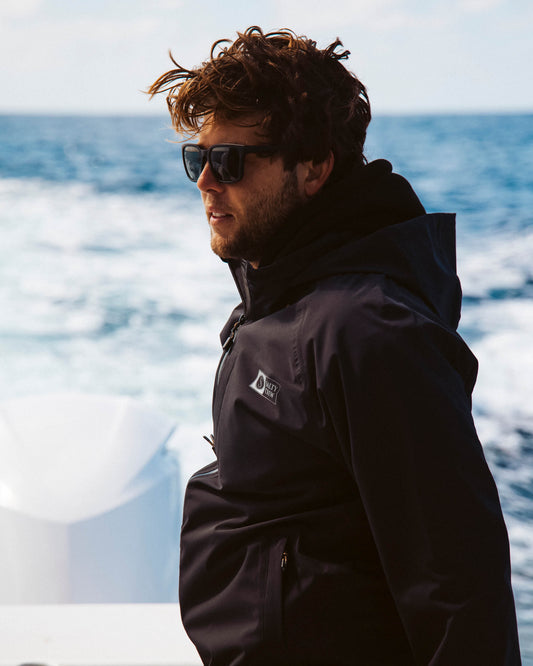 Lifestyle photo of the Long Range Jacket - Black. 