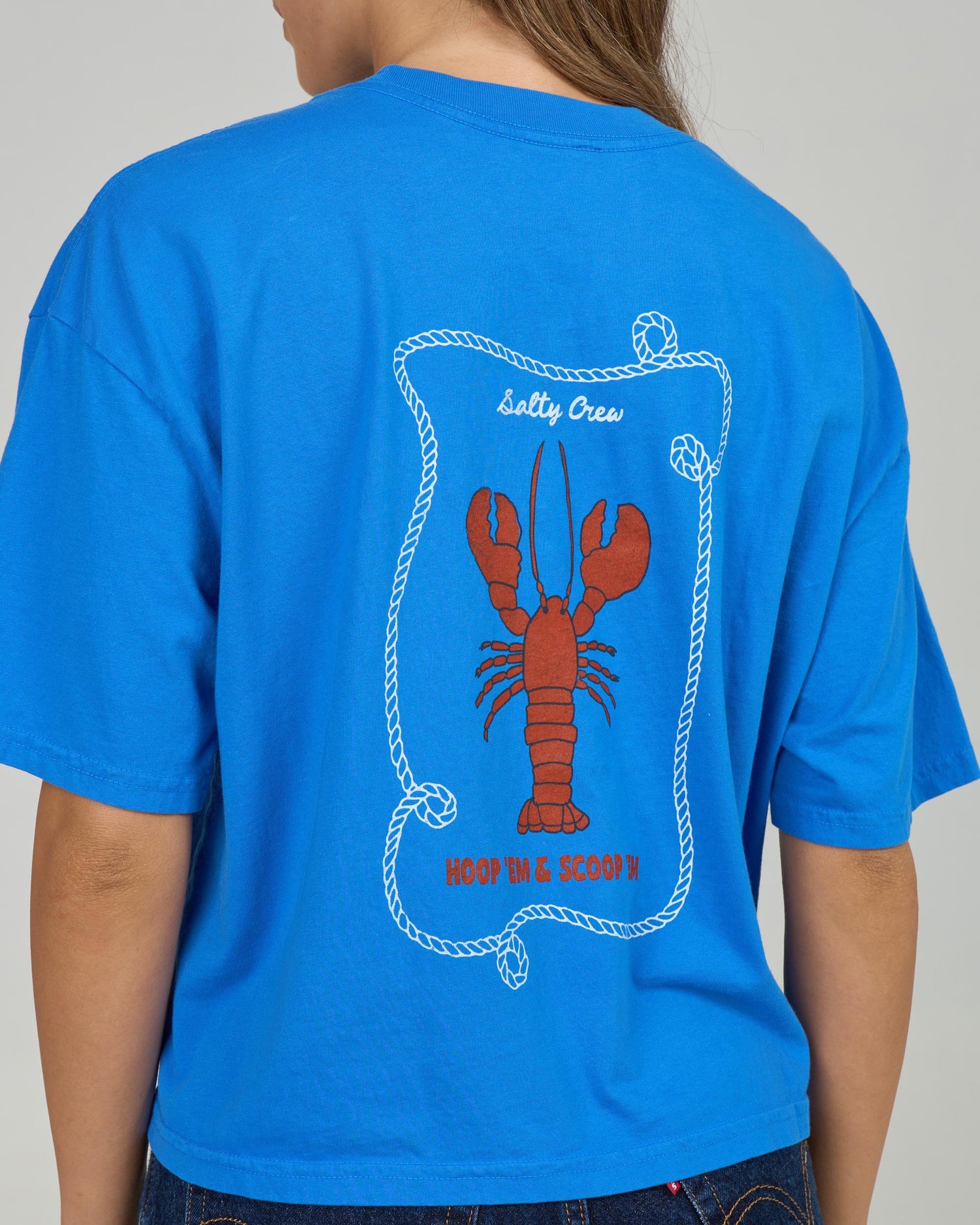 Close up back view of the Shellbrate Skimmer Tee - Bold Blue. 