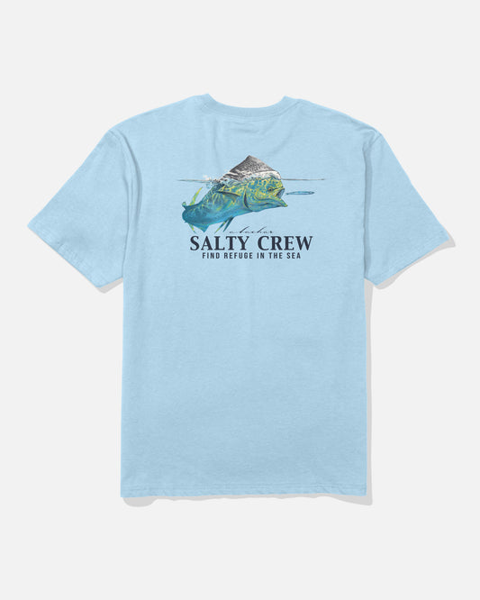 The Salty Crew Mahi Surface Classic Tee in Clear Sky is a 100% cotton light blue shirt featuring a mountain, water, and fish graphic on the back with “Salty Crew” and “Find Refuge in the Sea” printed below.