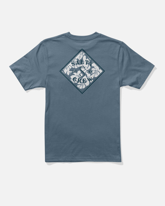 The Salty Crew Tippet Fill Boys Tee in Slate Blue is a 100% combed ringspun cotton short-sleeve shirt, featuring a screenprinted diamond-shaped graphic on the back with white leaves, a fish, and the text SALTY CREW.