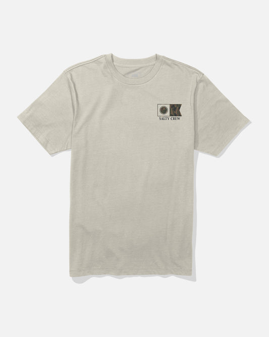 The Flagship Crew Tee - Bone by Salty Crew is a light bone short-sleeve t-shirt made from soft combed ringspun cotton. It features a small screenprinted patch with a fish illustration and circular logo, along with SALTY CREW text on the left chest. Shown laid flat on a white background for detail.