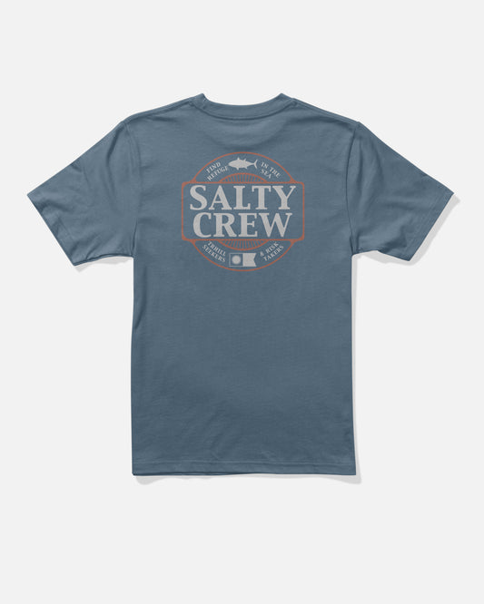 The Split Up Boys Tee by Salty Crew is a slate blue short-sleeve cotton t-shirt, featuring a large cream and orange Salty Crew logo screenprinted on the back, surrounded by fish illustrations and ocean-inspired phrases. Made from combed ringspun cotton for comfort.