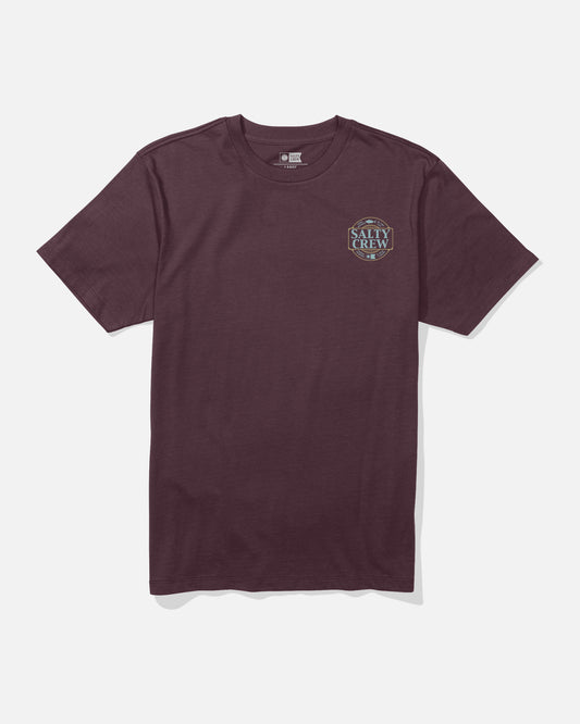 The Split Up Crew Tee by Salty Crew is a wine-colored, short-sleeve cotton t-shirt featuring a small circular Salty Crew logo screenprinted on the left chest. The combed ringspun tee is displayed flat against a plain white background.