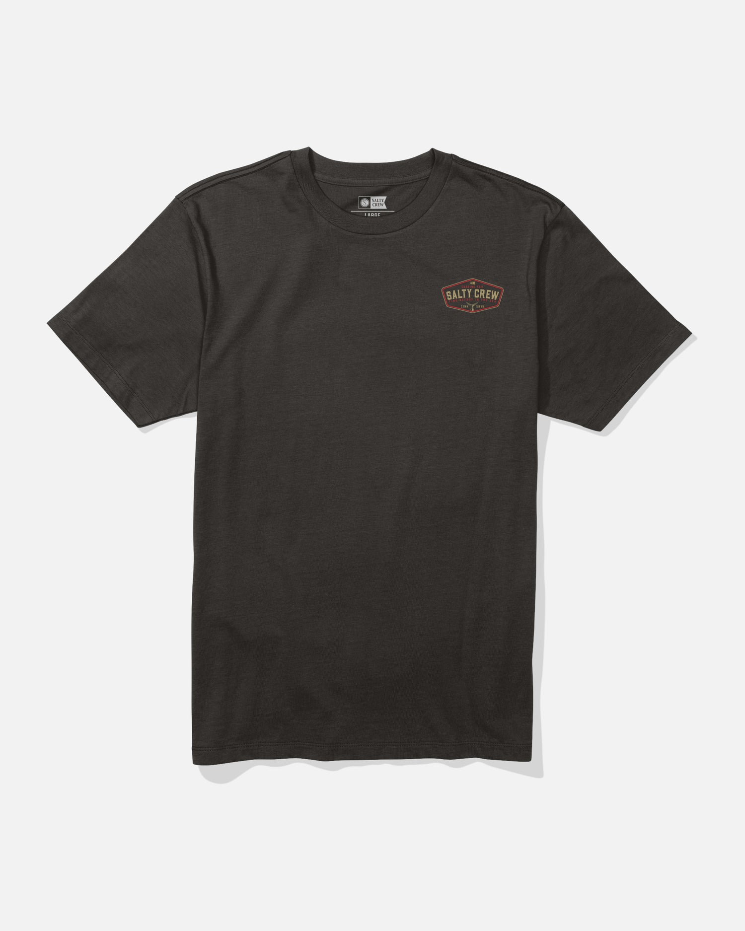The Salty Crew Tailfin Crew Tee in black is a combed ringspun cotton t-shirt featuring a small, circular Salt Crew logo in orange and white screenprinted on the left chest. The shirt is displayed laid flat on a white background.