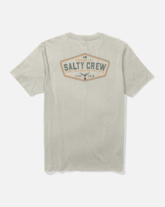 The Tailfin Crew Tee - Bone by Salty Crew is a beige short-sleeve t-shirt made from combed ringspun cotton, shown from the back and featuring a diamond-shaped Salty Crew logo along with the phrases “Chasing Tail,” “Find Refuge in the Sea,” and “Sink or Swim” in brown and blue screenprinted text.