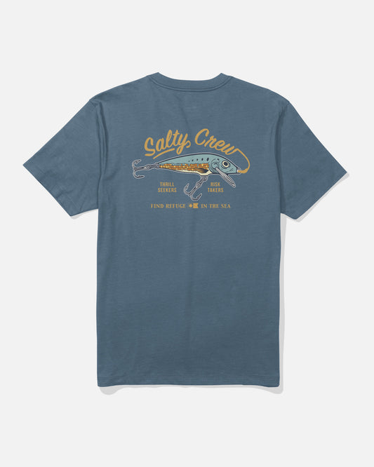 The Salty Crew Decoy Crew Tee in Slate is a blue cotton t-shirt featuring a screenprinted graphic of a fish and the text “Salty Crew, Thrill Seekers, Risk Takers, and Find Refuge in the Sea” on the back.
