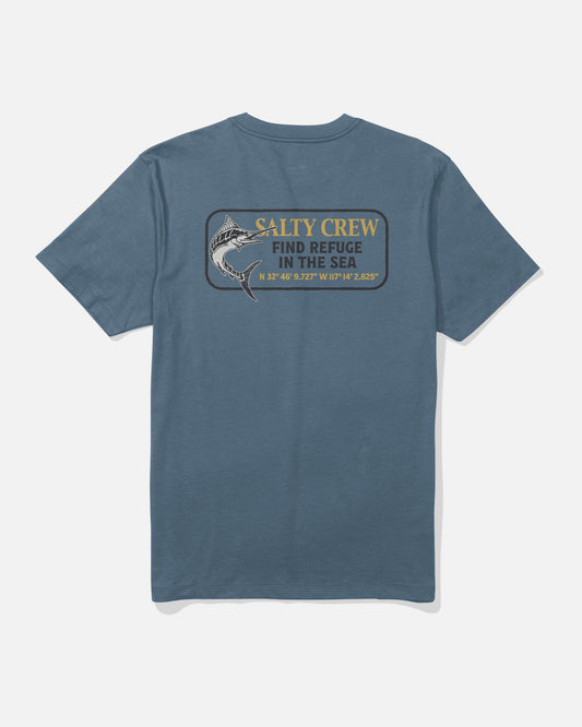 The Coordinates Crew Tee - Slate by Salty Crew is a blue cotton t-shirt showcasing a screenprinted fish graphic with the words “SALTY CREW FIND REFUGE IN THE SEA” and printed latitude and longitude coordinates beneath. Made from soft combed ringspun cotton for all-day comfort.