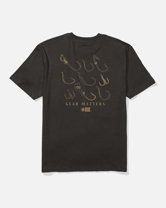 The Salty Crew Fish Gear Original Tee - Black is crafted from 100% soft spun cotton for superior comfort and features line art illustrations of various fishing hooks screenprinted on the back above the words “GEAR MATTERS,” along with a small round logo.