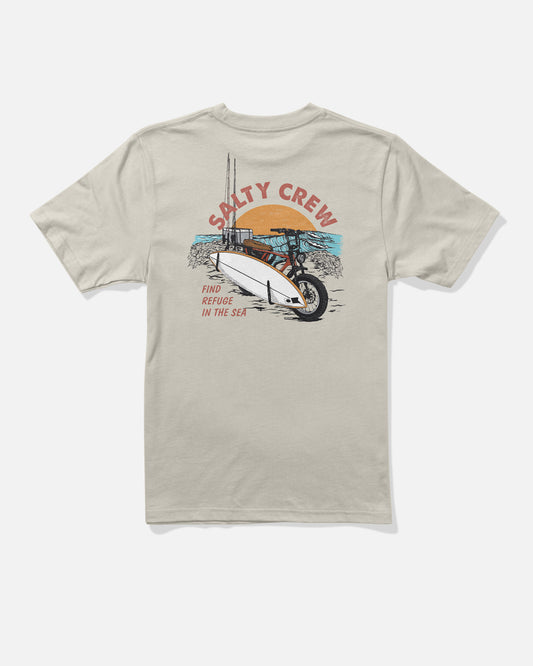 The Beach Cruiser Boys Tee - Bone by Salty Crew is a beige, combed ringspun cotton t-shirt featuring a screenprinted illustration of a bike carrying a surfboard by the beach, with “SALTY CREW” printed above and “FIND REFUGE IN THE SEA” below.