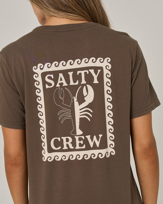 A person wearing the Salty Crew Lobster Roll Boyfriend Tee in washed brown, a relaxed fit shirt featuring a cream lobster graphic and “SALTY CREW” text on the back, all framed by a wavy border.