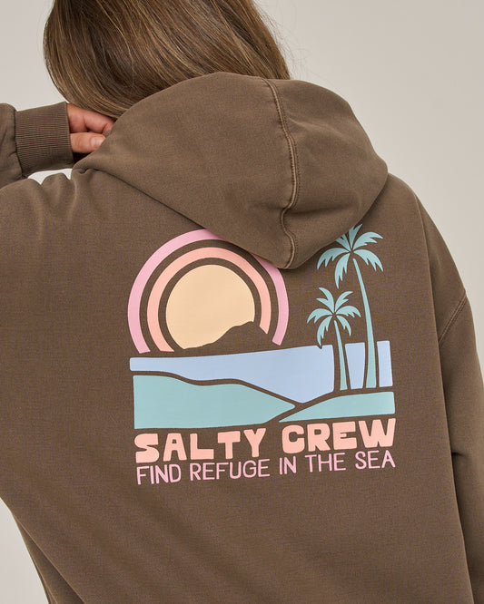 A person wears the Salty Crew Sushi Roll Hoodie in washed brown, crafted from soft cotton fleece. The back showcases a pastel-colored graphic featuring a sunset, palm trees, and the phrase “Salty Crew Find Refuge in the Sea.” A classic kangaroo pocket adds to this laidback style.