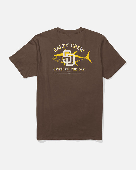 The Padres Catch of the Day Tee - Brown by Salty Crew features a yellow fish graphic with “Salty Crew” above and “Catch of the Day” below, along with a stylized SD logo in the center—perfect for fans of both Salty Crew and the San Diego Padres.