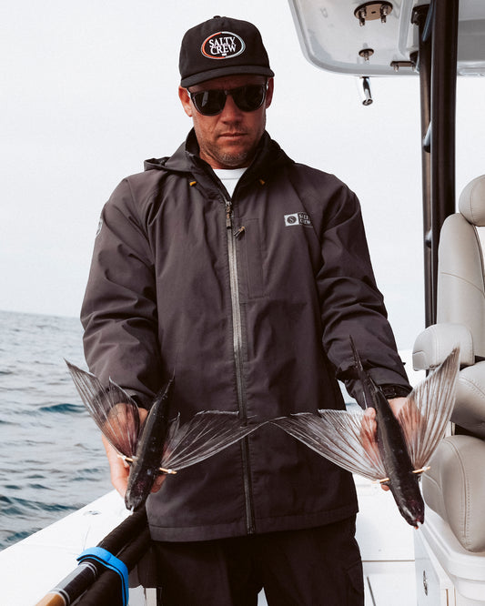 Lifestyle shot of the Long Range Jacket - Black. 