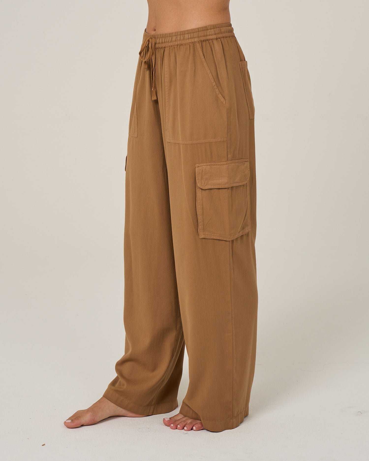 Profile view of the Driftwood Pant - Bronze Brown. 