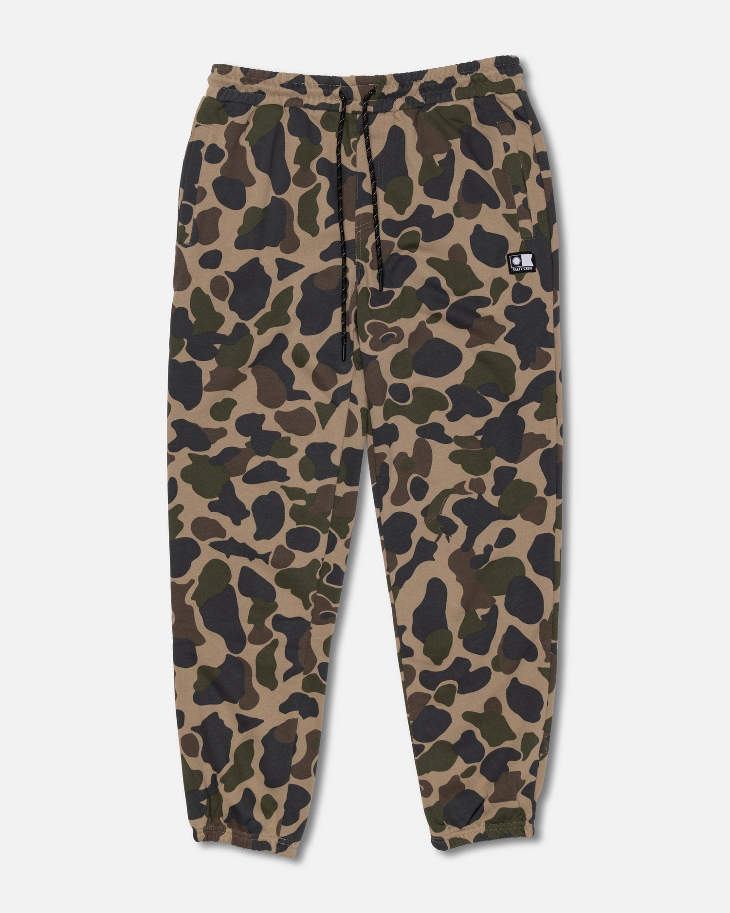 The Salty Crew Crewser Fleece Pant in Sand Camo features an elastic waistband with a drawstring, elastic cuffs, convenient side hand pockets, and a small black patch on one front pocket. The pants showcase a green, brown, and black camouflage pattern.