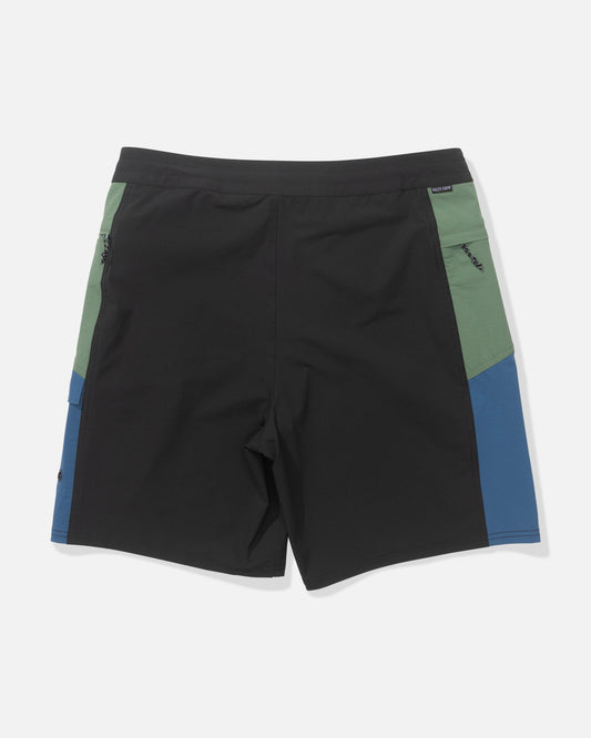 The Salty Crew Flagship 20" Boatshort - Cast Blue features a black front, green upper side panels, and blue lower side panels, all in 4-way stretch fabric, displayed against a white background.