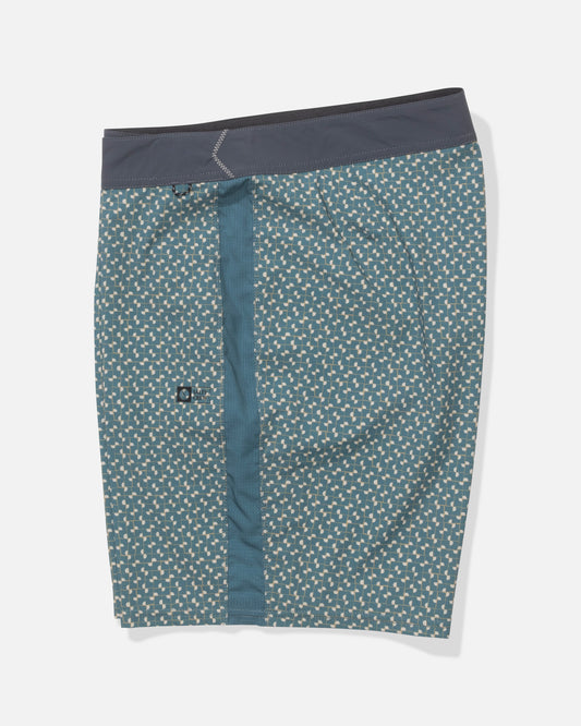 The Salty Crew Channel 18" Apex Boardshort in Oceanic features a teal shade with a cream geometric print, dark gray waistband, and quick-dry performance fabric, shown laid flat on a white background.