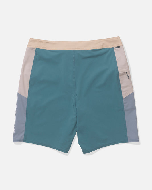 Salty Crew's Flagship 20" Boardshort - Oceanic features teal with beige and gray color-block panels, an elastic beige waistband, and a right zip pocket. Made from quick-dry performance fabric. Shown laid flat on a white background.