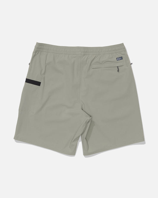 Salty Crew Crew 18″ Ewaist Boatshort in Aqua Grey features an elastic waistband, a zippered back pocket on the right with a small logo patch beside it, and a black horizontal accent on the left. Made from quick-dry ripstop fabric for superior durability and comfort, these shorts are displayed flat against a white background.