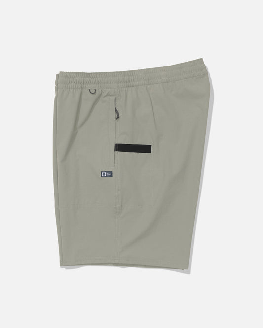 The Salty Crew Crew 18″ Ewaist Boatshort in Aqua Grey is displayed flat on a white background, featuring an elastic waistband, small logo tag, zipper pocket, and a black horizontal accent on the side. Made from quick-dry ripstop fabric, these shorts provide durability and comfort for every workout.
