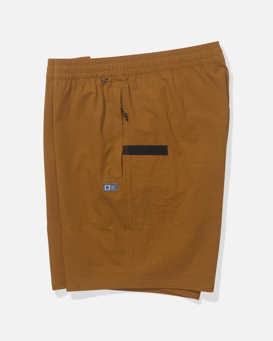 The Salty Crew Crew 18" Ewaist Boatshort in Bronze Brown features an elastic waistband, zippered fly, small front pocket with a black accent, logo tag below the pocket, and is made from quick dry ripstop fabric. Shorts shown laid flat on white background.