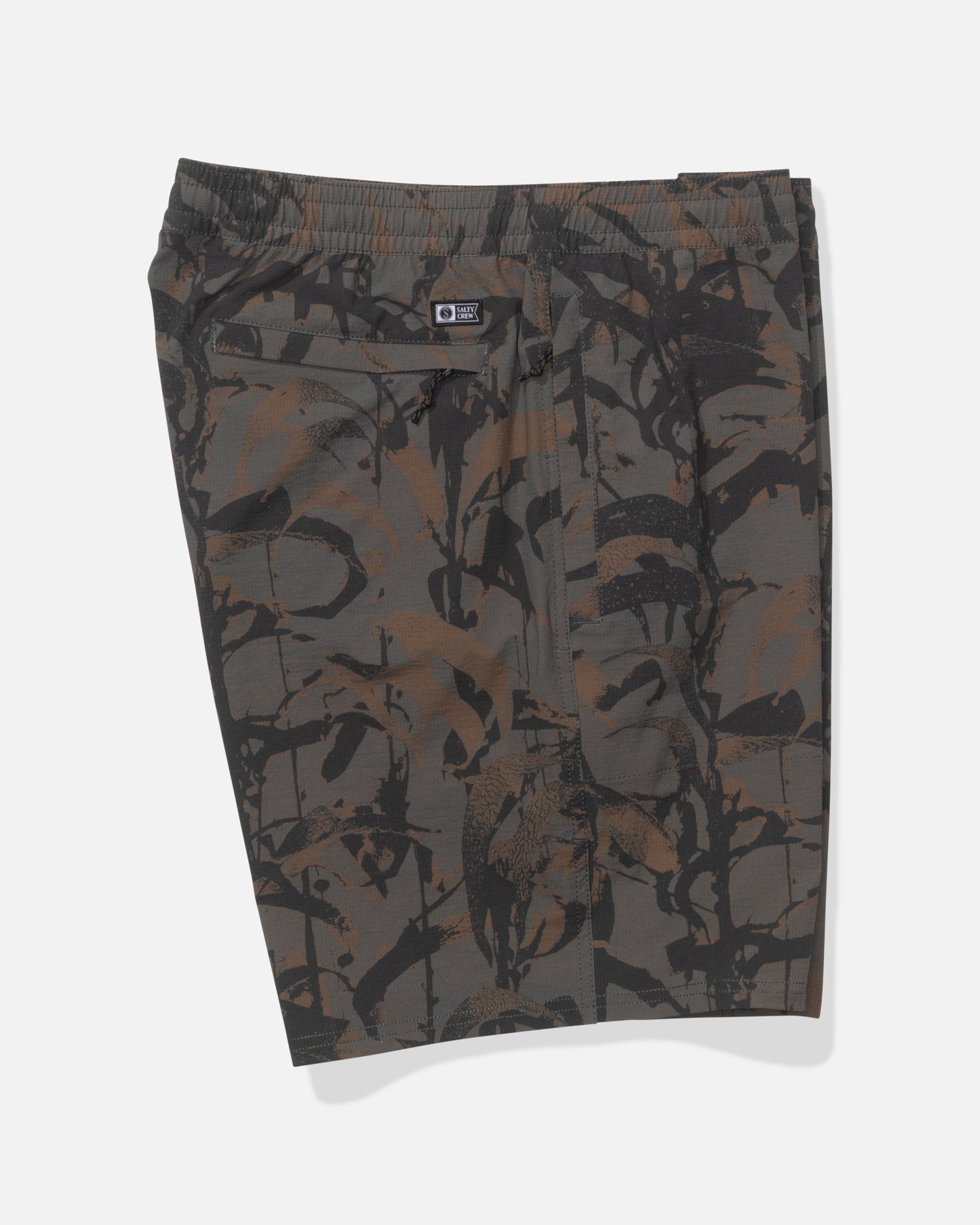 The Salty Crew Crew 18" Ewaist Boatshort in Dark Kelp Camo features knee-length ripstop shorts with an elastic waistband and a brown, black, and gray abstract camo pattern, shown flat against a white background.
