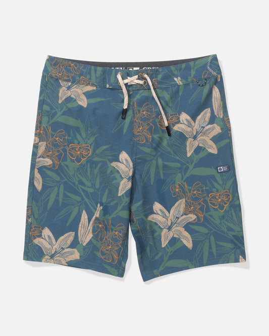 The Salty Crew Boys Boardshort in Cast Blue features a drawstring waist, straight leg fit, and comfort fabric. Designed with a green and tan tropical floral print and a small rectangular logo patch on the left leg, shown laid flat on a white background.