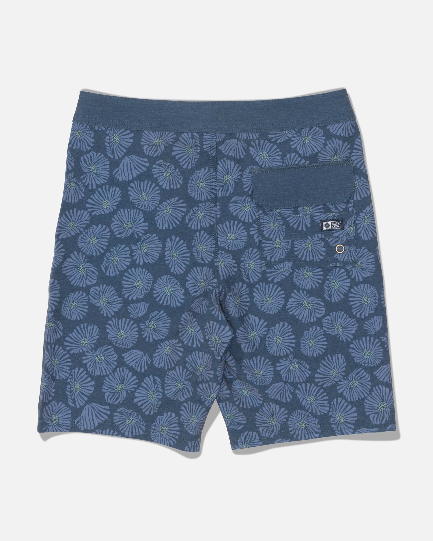 The Crew 17″ Boys Boardshort in Hitch Blue by Salty Crew features a green and blue leaf pattern, crafted from recycled polyester comfort fabric with 4-way stretch for easy movement. Practical details include an elastic waistband and a single back pocket with a small label and metal grommet. The shorts are shown laid flat on a white background.