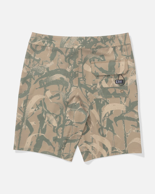 The Salty Crew Crew 17" Boys Boardshort in Sand Camo features a beige and green camo pattern, recycled polyester fabric for sustainability, and a single back pocket with a black logo patch and flap closure.