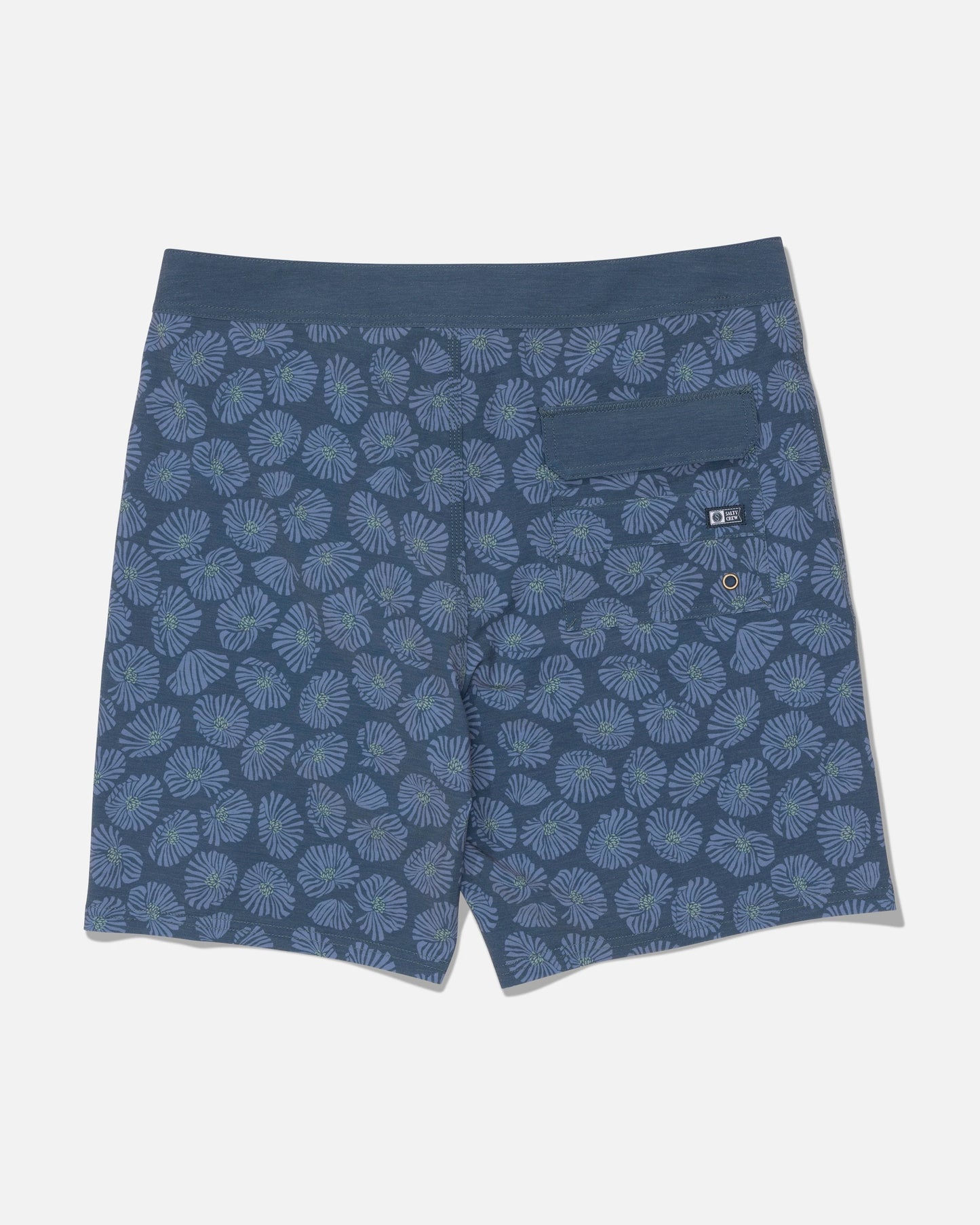 The Salty Crew Crew 19″ Boardshort in Hitch Blue is shown from the back, featuring a light blue and green floral pattern. Made from recycled polyester with 4-way stretch for enhanced comfort, these boardshorts have a straight leg cut. They include a single right-side pocket with a button flap and a small grommet for drainage.