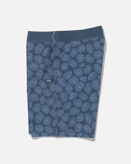 Crew 19″ Boardshort in Hitch Blue by Salty Crew, shown flat on a white background. These boardshorts feature a light blue and green floral pattern, crafted from recycled polyester with 4-way stretch for maximum comfort, and include a small black logo tag on the waistband.