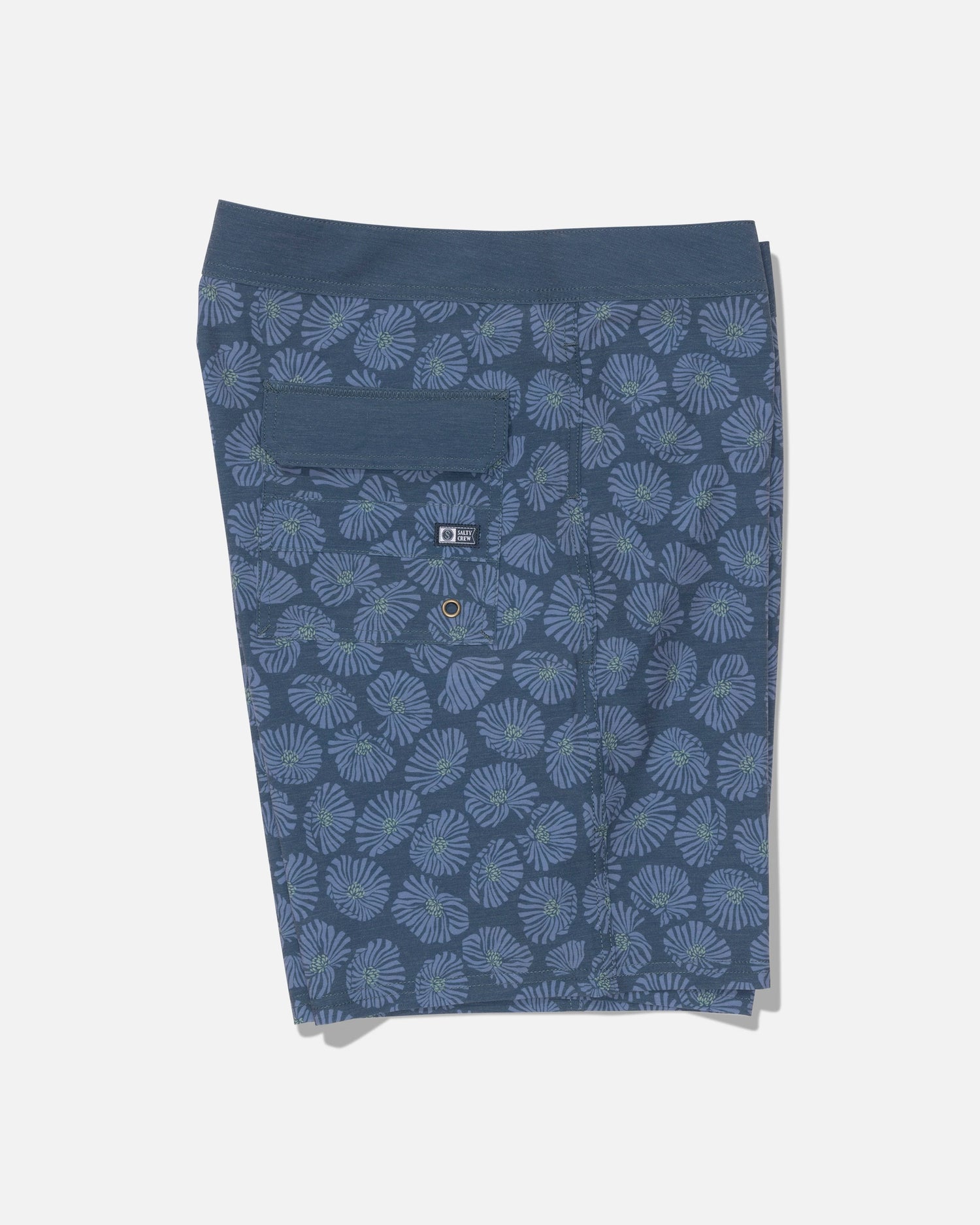 Introducing the Salty Crew Crew 19″ Boardshort in Hitch Blue—these straight leg boardshorts feature a subtle light blue floral pattern, a button-flap back pocket with an additional smaller pocket below, and are crafted from recycled polyester for an eco-friendly touch. Displayed against a plain white background.