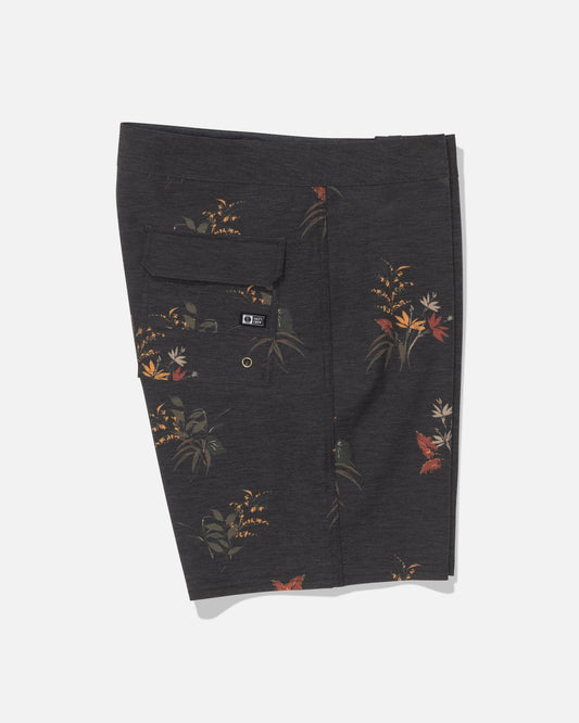 Salty Crew’s Crew 19″ Boardshort in Off Black features a subtle earth-toned floral print on dark gray recycled polyester comfort fabric for an eco-friendly feel. Designed with a back flap pocket secured by a button and finished with a small black Salty Crew brand tag, these stylish and sustainable boardshorts are shown flat against a white background.