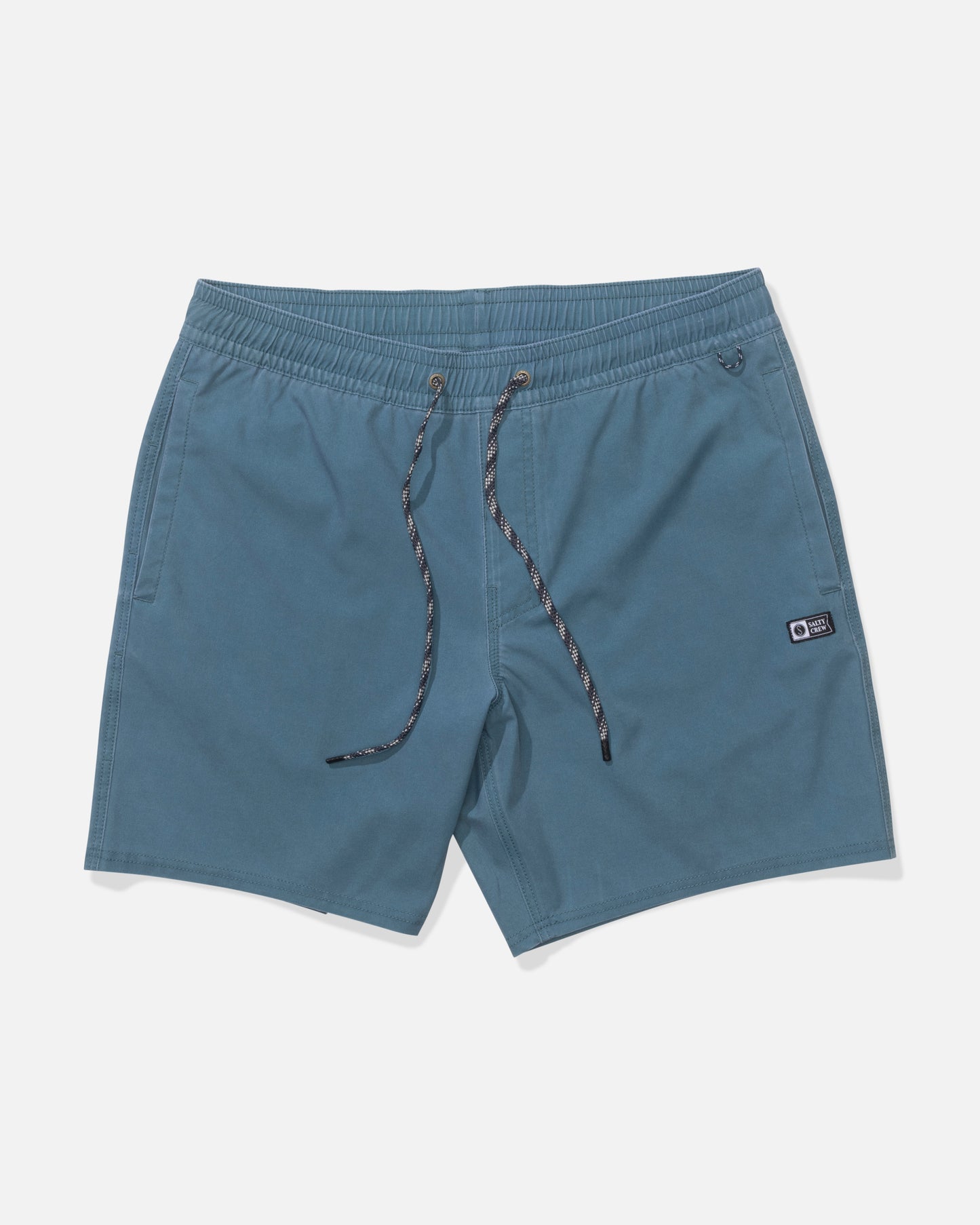 The Salty Crew Seadog Volley 17" - Hydro shorts feature blue performance fabric, an elastic waistband, side pockets, quick-dry material, and a small patch logo on the left leg, shown laid flat on a white background.