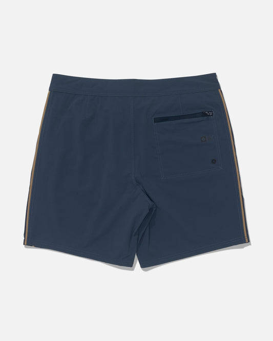 Salty Crew Channel 18″ Apex Boardshort in navy, featuring straight leg design, tan side stripes, a back zippered pocket, quick-dry fabric, and 4-way stretch, laid flat on a white background.
