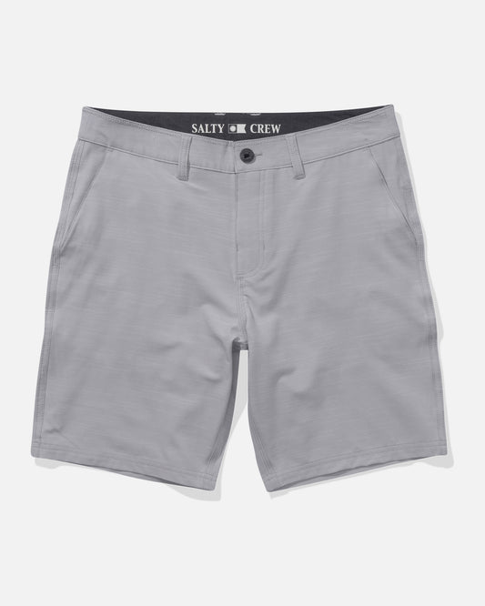 The Salty Crew Drifter 19″ Slub Hybrid Short in Light Grey is shown laid flat on a white background. These men’s shorts feature side pockets, belt loops, and a button closure. Made from recycled performance fibers with 4-way stretch for exceptional comfort and mobility, they offer quick-dry functionality. The inner waistband is detailed with the Salty Crew brand name.
