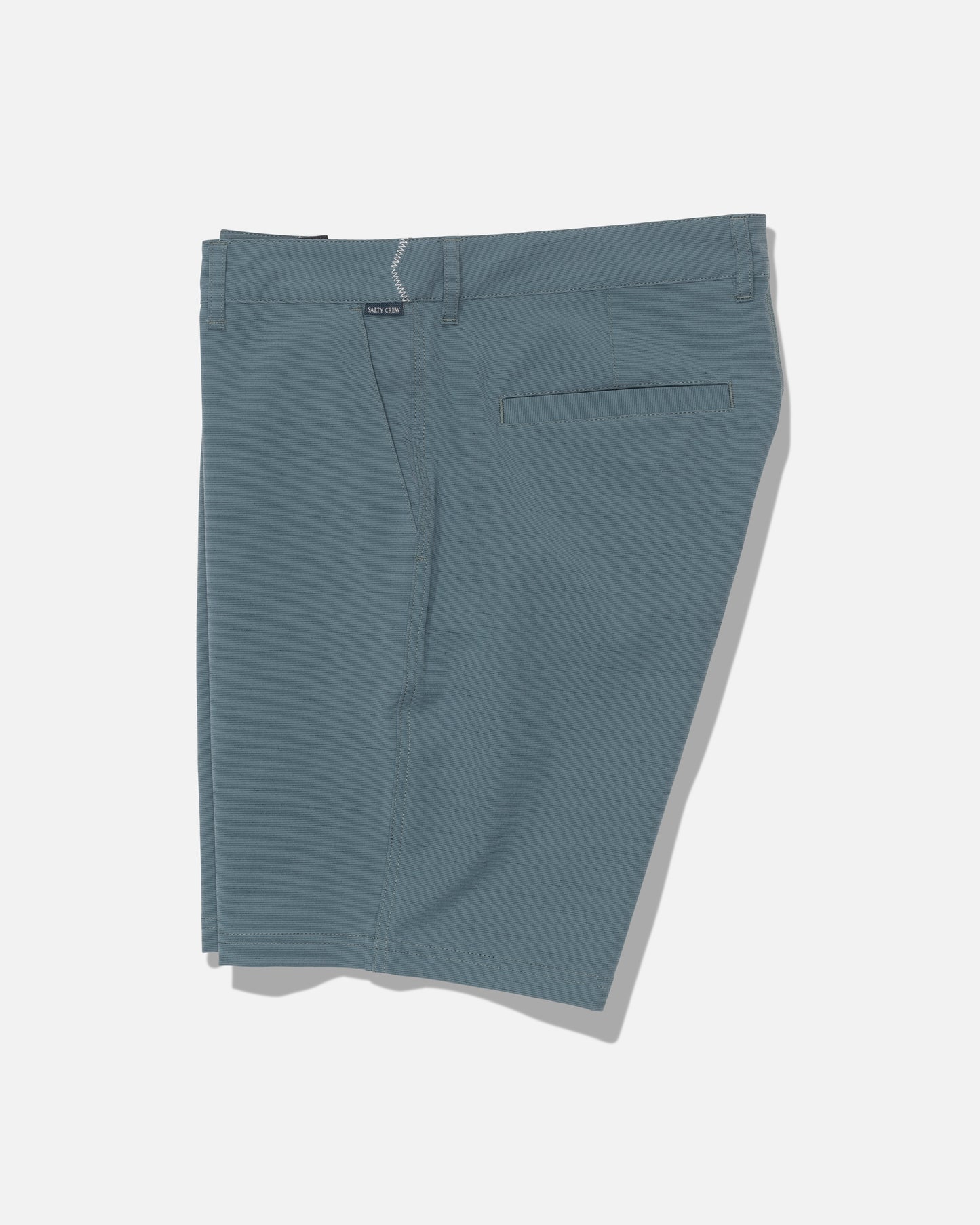 The Salty Crew Drifter 19″ Slub Hybrid - Mid Ocean men’s shorts appear in light blue-green, crafted from recycled performance fabric. Featuring belt loops, a front zipper, flat front design, and a single back pocket, these shorts offer 4-way stretch for comfort and flexibility. Quick-drying and neatly laid flat on a white background.