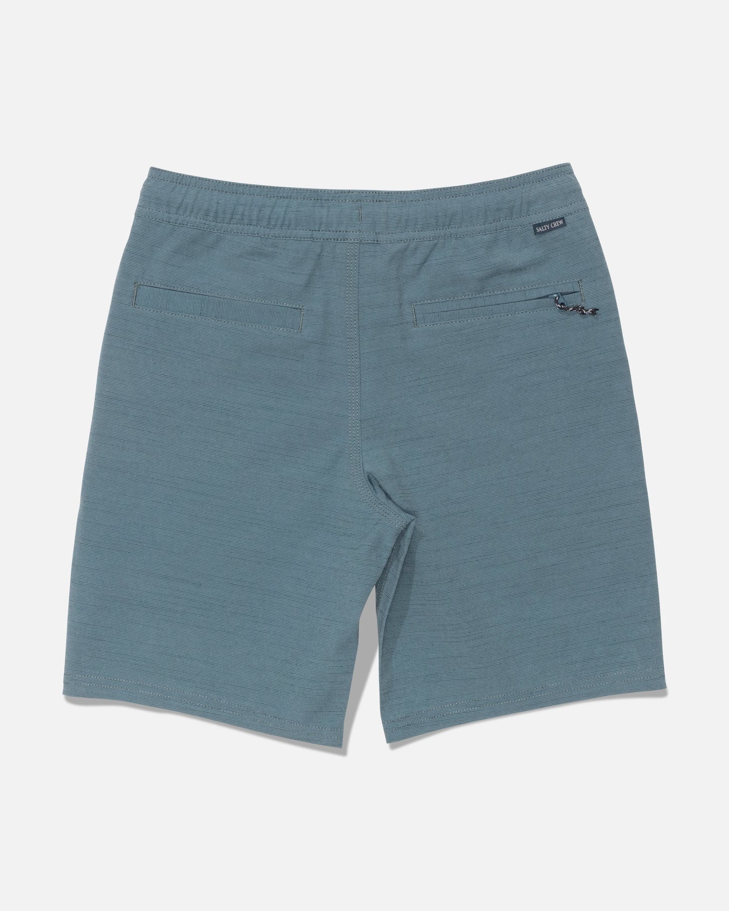 Back view of the Salty Crew Drifter 16″ Boys Elastic Hybrid shorts in Mid Ocean blue, featuring two rear pockets, an elastic waistband with a small black label, and a keychain attachment on the right pocket.