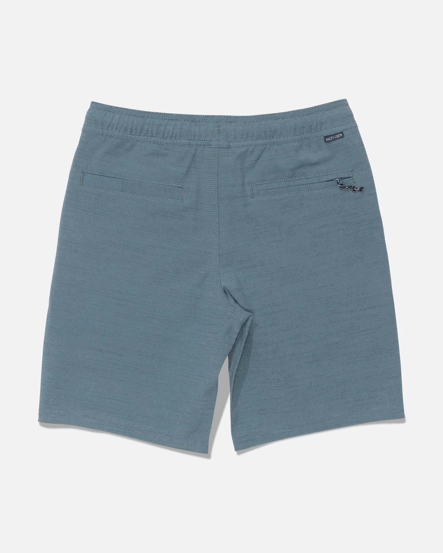 Back view of the Salty Crew Drifter 16″ Boys Elastic Hybrid shorts in Mid Ocean blue, featuring two rear pockets, an elastic waistband with a small black label, and a keychain attachment on the right pocket.