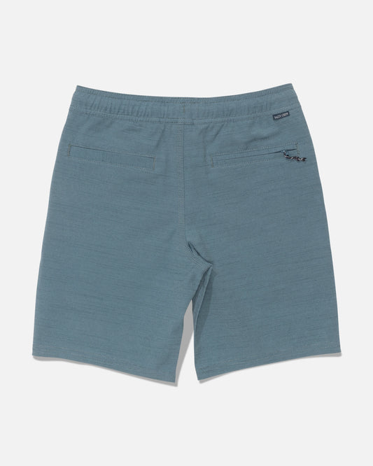 Back view of the Salty Crew Drifter 16″ Boys Elastic Hybrid shorts in Mid Ocean blue, featuring two rear pockets, an elastic waistband with a small black label, and a keychain attachment on the right pocket.