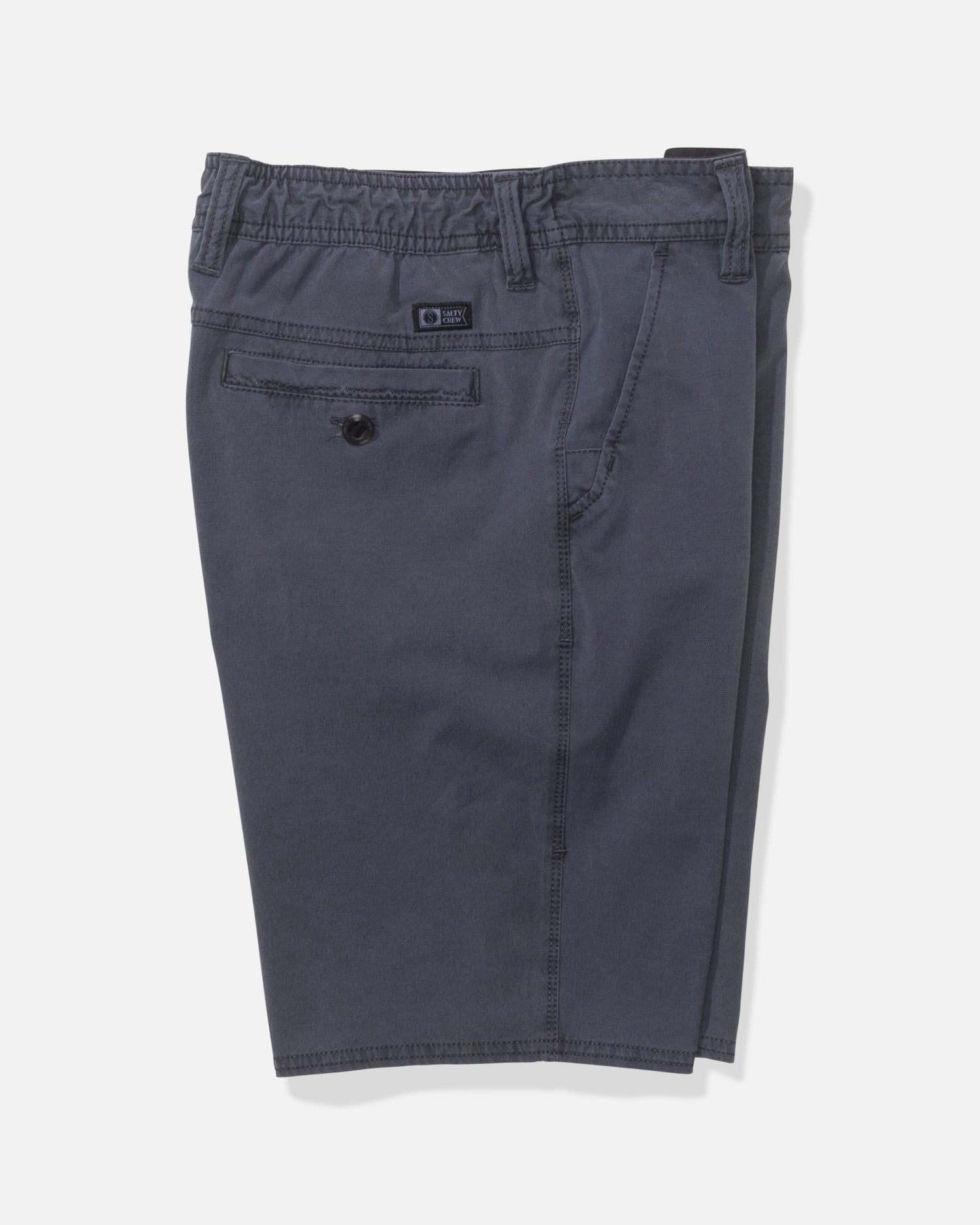 The Salty Crew Transom 17" Boys Overdye Short in Magnet features a dark gray straight leg design with an elastic waistband, belt loops, a buttoned back pocket, and visible stitching, shown on a plain white background.