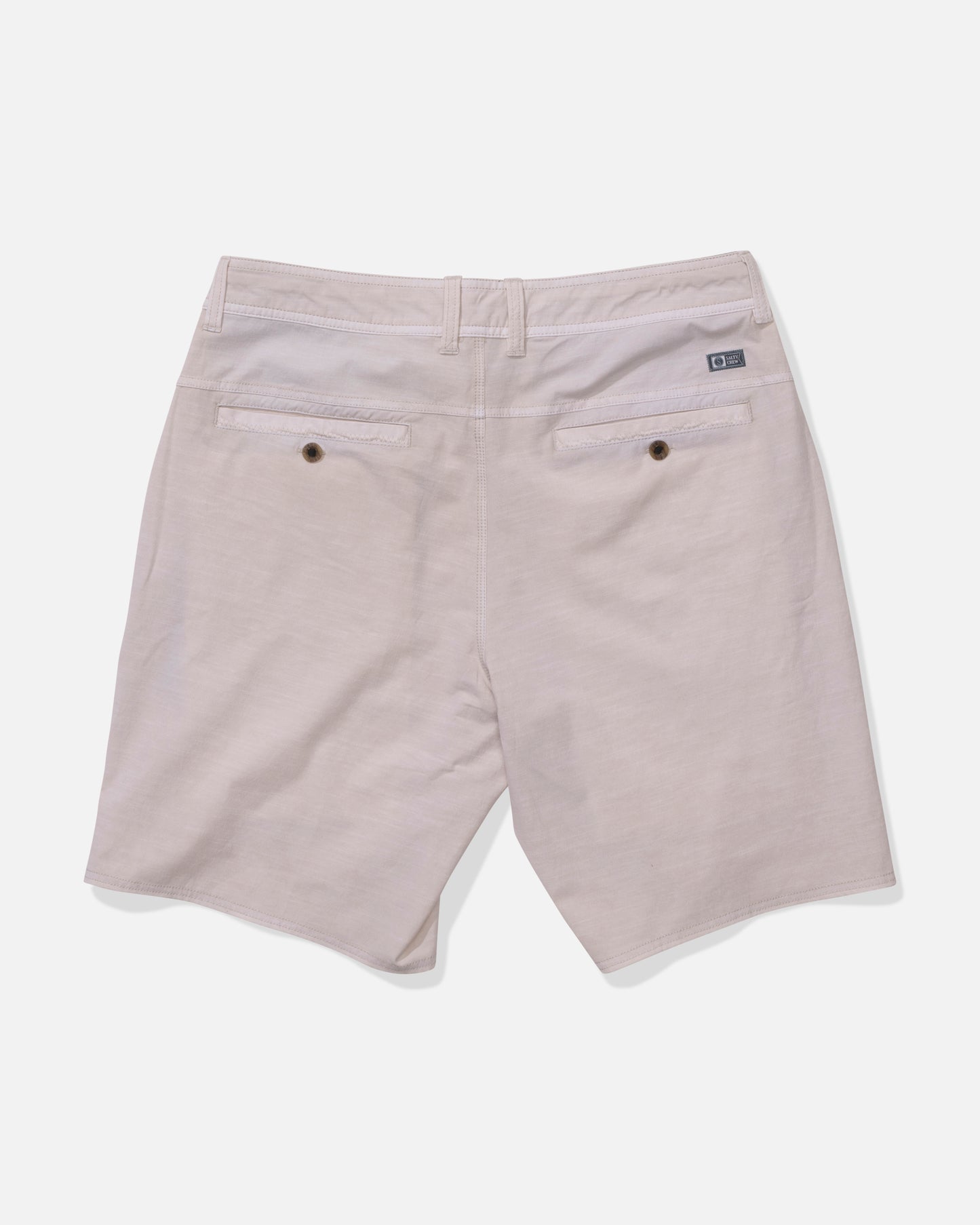 Back view of Salty Crew Transom 19" Overdye Short in Natural, showing two back pockets with button closures, belt loops, and a logo tag above the right pocket. Made from quick dry fabric and displayed against a white background.