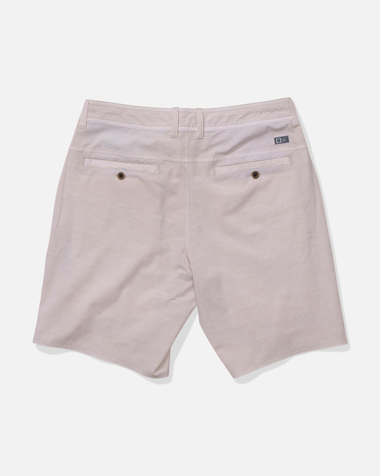 Back view of Salty Crew Transom 19" Overdye Short in Natural, showing two back pockets with button closures, belt loops, and a logo tag above the right pocket. Made from quick dry fabric and displayed against a white background.