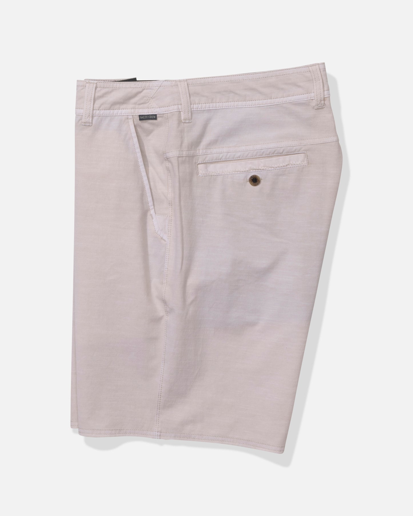 The Salty Crew Transom 19" Overdye Short in Natural features a clean, minimal look with belt loops, a buttoned back pocket, and quick-dry fabric for all-day comfort—men's shorts photographed on a white background.
