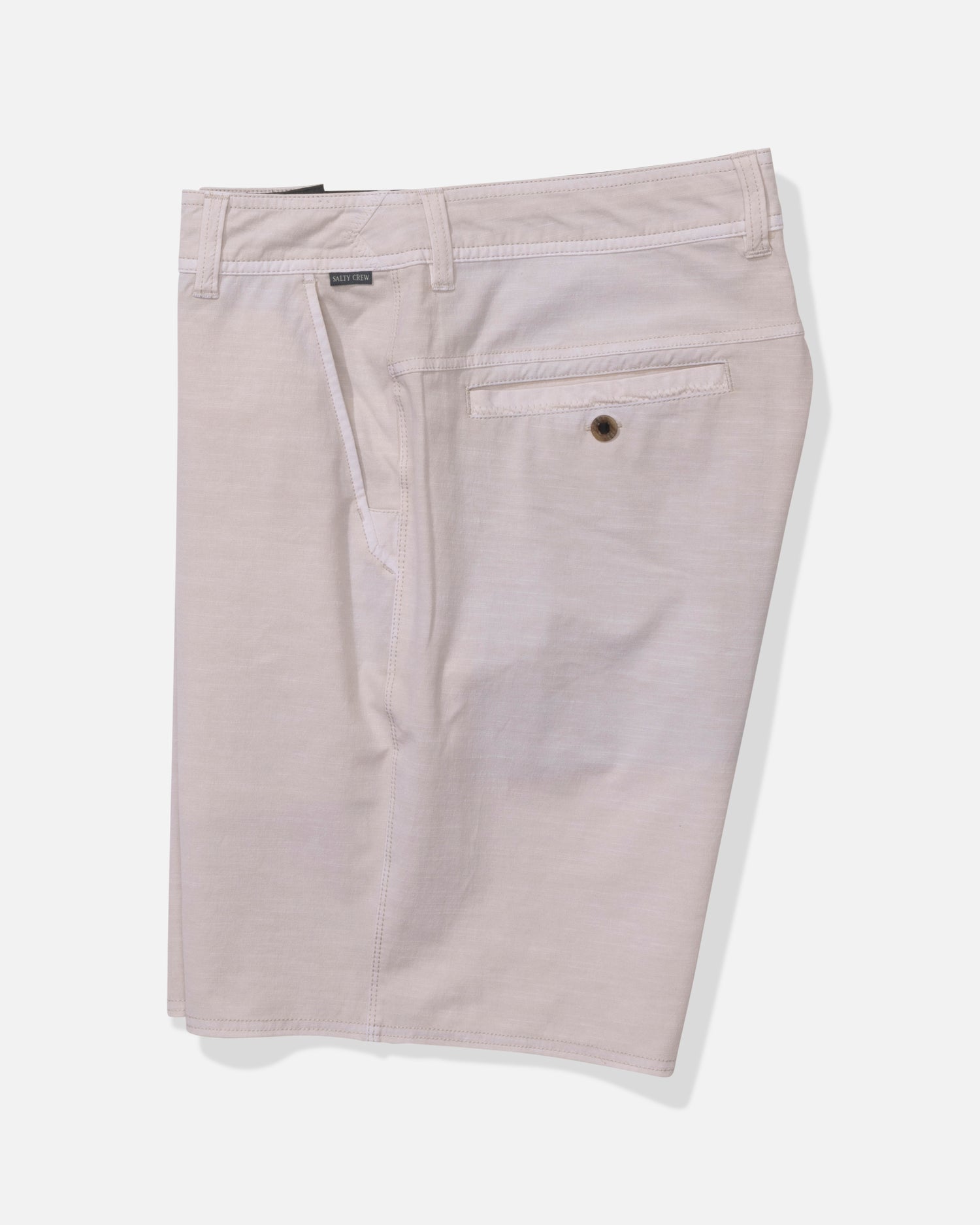 The Salty Crew Transom 19" Overdye Short in Natural features a clean, minimal look with belt loops, a buttoned back pocket, and quick-dry fabric for all-day comfort—men's shorts photographed on a white background.